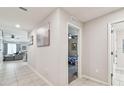 Bright hallway with tile flooring gives way to a living area and bedroom, creating an inviting flow throughout the home at 3886 Reflection Dock Dr, Seffner, FL 33584