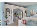 Inviting foyer with tiled floors, stylish columns, arched entryways, neutral paint, and views to the living room and back yard at 4009 Clear Spring Rd, Brooksville, FL 34604