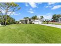 Spacious single-story home with a large front yard, two-car garage, and well-maintained landscaping at 487 Waterloo Ct, Spring Hill, FL 34609