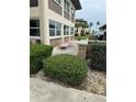 Condo exterior with beige and brown siding, trimmed windows and landscaping at 5111 Amulet Dr # 102, New Port Richey, FL 34652