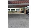 Designated parking area with covered roof and marked parking spots for units 101 and 102 at 5111 Amulet Dr # 102, New Port Richey, FL 34652