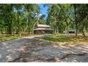 Lovely home exterior with a charming covered porch and a picturesque, tree-filled yard at 5363 Utopia Pl, Brooksville, FL 34601