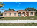 Charming home featuring a well-manicured lawn and inviting front entrance with stylish architectural details at 5423 Abagail Dr, Spring Hill, FL 34608