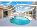 Inviting screened-in pool area with clear blue water, perfect for relaxation and entertainment at 5423 Abagail Dr, Spring Hill, FL 34608
