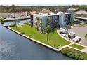 Condo building with waterfront access, well-maintained landscaping, and convenient parking at 5627 Ferguson Ct # 1303, New Port Richey, FL 34652