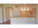 Bright, open kitchen layout with wooden cabinetry and a breakfast bar at 5701 Brackenwood Dr, Spring Hill, FL 34609