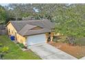 An overhead view of a home with a spacious yard, driveway, and mature trees at 6315 Shane Ln, New Port Richey, FL 34653