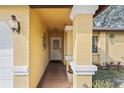 Inviting front porch with decorative columns and manicured landscaping at 6315 Shane Ln, New Port Richey, FL 34653