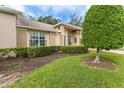 Well-maintained front yard with lush greenery and attractive landscaping at 7392 Willow Brook Dr, Spring Hill, FL 34606