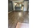 Open-concept living space featuring wood floors connecting to the kitchen area at 7802 Hardwick Dr # 1116, New Port Richey, FL 34653