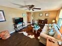 Cozy living room features stylish decor, wood-look tile floors, and comfortable seating at 7861 Raintree Dr, New Port Richey, FL 34653