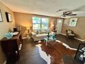 Inviting living room boasts ample natural light, stylish furniture, and a cozy atmosphere at 7861 Raintree Dr, New Port Richey, FL 34653