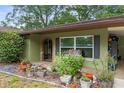 Inviting front porch with decorative flower pots, a bench, and unique brick archway at 8102 Fort Dade Ave, Brooksville, FL 34601