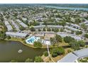 An aerial view shows a desirable community with lake, pool, recreational center and multiple residential buildings at 8405 112Th St # 103, Seminole, FL 33772