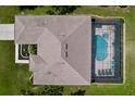 An aerial view reveals a well-maintained home with a screened-in pool and a spacious backyard at 9152 Bunting Rd, Weeki Wachee, FL 34613