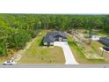 Aerial view of a well manicured home with mature trees on a lush green lot at 10380 Yellow Hammer Rd, Weeki Wachee, FL 34614