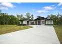 Beautiful single story house with large driveway, well-kept lawn and mature landscaping at 10380 Yellow Hammer Rd, Weeki Wachee, FL 34614