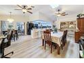 Open floor plan with breakfast nook, kitchen bar, dining room, and seamless flow to other spaces at 10411 Ireland St, Spring Hill, FL 34608
