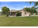 Charming single-story home featuring stone accents, a covered patio, and a well-maintained front lawn at 10441 Mayflower Rd, Spring Hill, FL 34608