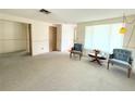 Bright living room with neutral carpeting, ample natural light, and classic decor at 11034 Harding Dr, Port Richey, FL 34668