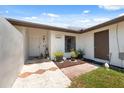 Charming single-story home with neutral paint, brown roof, landscaping, and a walkway at 11402 Shallowbrook Pl, Tampa, FL 33624