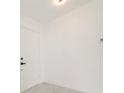 Bright entryway showcases a modern white door, marble floors, and a contemporary aesthetic at 11494 Villa Rd, Spring Hill, FL 34609