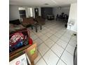 Spacious living room with tile flooring, seating area, and dining space at 11726 Oceanside Dr, Port Richey, FL 34668