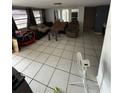 Bright living room featuring tile flooring, seating, and natural light at 11726 Oceanside Dr, Port Richey, FL 34668