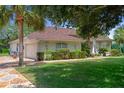 Beautiful home with a well-manicured lawn and a patterned driveway and walkway at 12403 Moneta Rd, Weeki Wachee, FL 34614