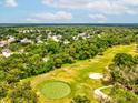 Scenic aerial view of the community golf course, surrounded by lush green trees at 12920 Wedgewood Way # B, Hudson, FL 34667