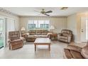 Inviting living room with neutral tones, tile flooring, and a comfortable seating arrangement at 12920 Wedgewood Way # B, Hudson, FL 34667