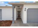 Home's front entrance features a secure door, brick-paved entryway, and clearly visible address at 13307 Woodward Dr, Hudson, FL 34667