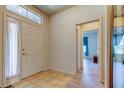 Foyer featuring neutral tile, high ceilings, and lots of natural light at 14466 Tamarind Loop, Spring Hill, FL 34609