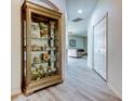 Hallway with gray wood floors leading to the living area at 14466 Tamarind Loop, Spring Hill, FL 34609