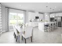 Bright and airy kitchen and dining area with white finishes, modern appliances, and ample natural light at 1705 W Palms Dr, Port Charlotte, FL 33953