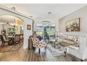 Cozy living room with plush seating, a decorative rug, and a view of the landscaped backyard at 18223 Nestlebranch Ct, Hudson, FL 34667