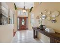 Bright foyer featuring tiled flooring, a decorative table, and arched doorways providing an inviting and elegant entrance at 19418 Morden Blush Dr, Lutz, FL 33558
