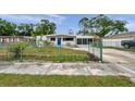 Charming home featuring a well-maintained yard, screened in porch, and long driveway at 2012 Warrington Way, Tampa, FL 33619