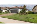 Charming single-story home with well-manicured lawn and a two car garage with a beautiful tile roof at 3051 Francoa Dr, Odessa, FL 33556