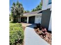 Home's inviting front entrance with lush landscaping and a charming walkway at 3304 Honeymoon Ln, Holiday, FL 34691