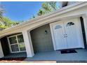 Charming front porch with double doors and ample natural light at 3304 Honeymoon Ln, Holiday, FL 34691
