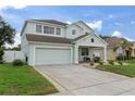 Beautiful two-story home with a two car garage, a inviting porch, and green landscaping at 4215 Maplehurst Way, Spring Hill, FL 34609