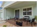 Inviting covered porch with stylish seating area and decorative plants at 4215 Maplehurst Way, Spring Hill, FL 34609