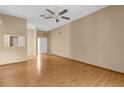 Spacious living room featuring wood floors, a ceiling fan, and ample natural light at 4221 San Rafael Ave, New Port Richey, FL 34655