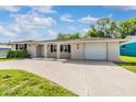 Inviting single-story home featuring a neatly maintained front yard and attached garage at 4468 Rudder Way, New Port Richey, FL 34652