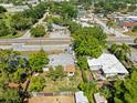 Overhead view of neighborhood with tree-lined streets and the property's backyard with mature trees at 5045 Grand Blvd, New Port Richey, FL 34652