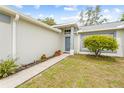 Welcoming front entrance with a neatly landscaped walkway and a well-manicured lawn at 5087 Oyster Ct, Spring Hill, FL 34607