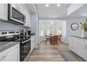 Bright kitchen with white cabinets, stainless steel appliances, and a breakfast nook with a bay window at 5087 Oyster Ct, Spring Hill, FL 34607