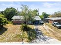 Single story home featuring a carport and mature landscaping at 5121 Hemlock Dr, New Port Richey, FL 34652