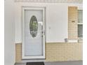 Elegant front door with oval glass insert, complemented by brick detailing and a welcoming entrance at 5642 Dove Dr, New Port Richey, FL 34652